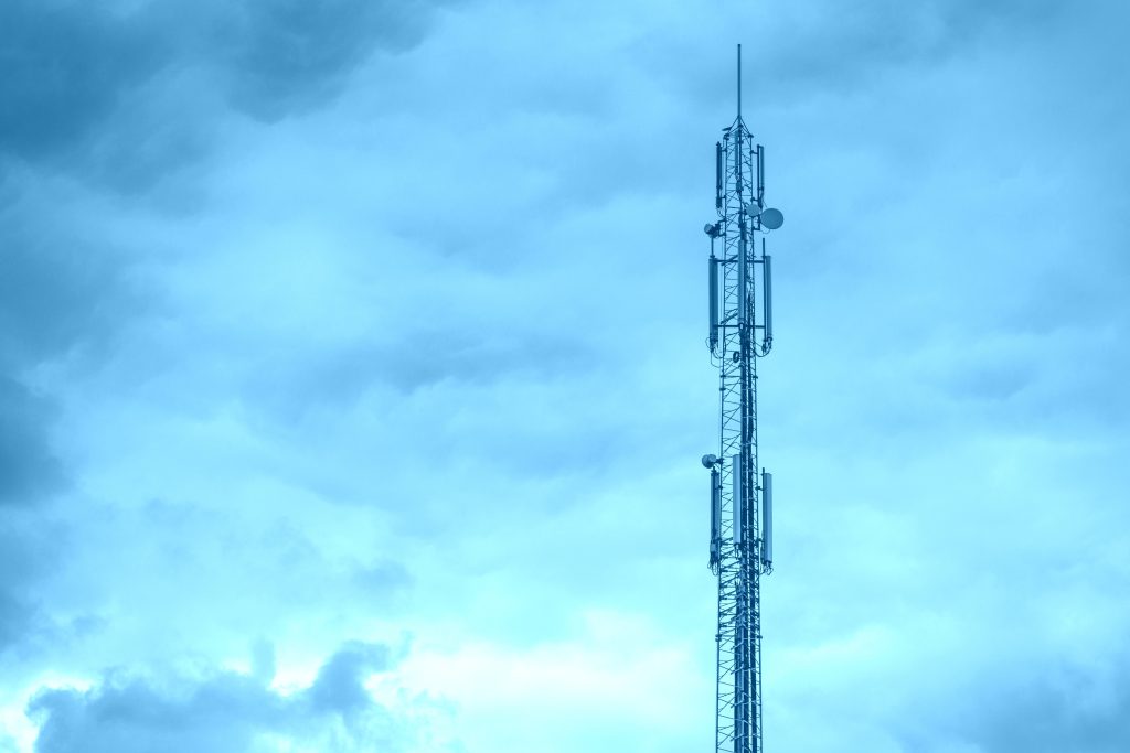 Lattice tower with mobile antennas against blue sky