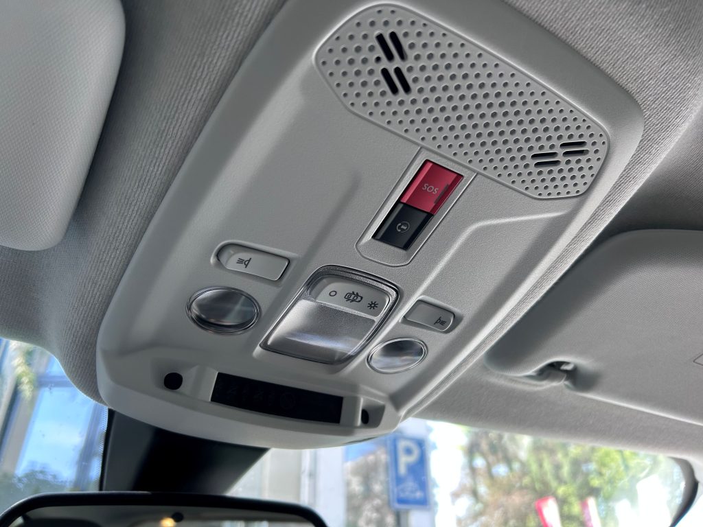 Overhead console in a passenger car, with red eCall button marked SOS
